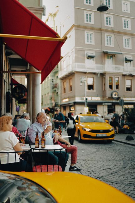 People enjoying outdoor dining in a vibrant street setting in Istanbul, Turkey.