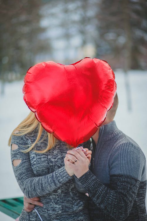 Free Couple Holding Hands With Red Heart Balloon Stock Photo