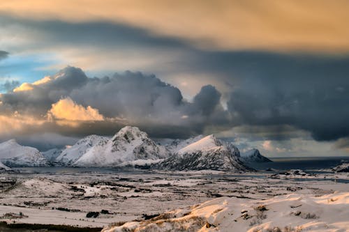 Scenic View of the Snowy Mountains Under Dark Clouds