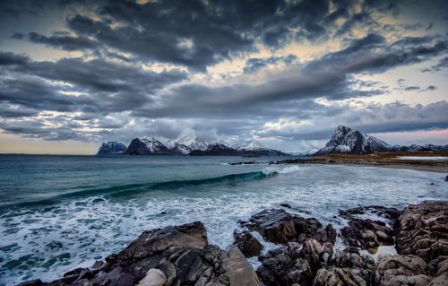 Free Breathtaking view of Storsandnes beach in Norway with rugged rocks and dramatic cloudscape at dusk. Stock Photo