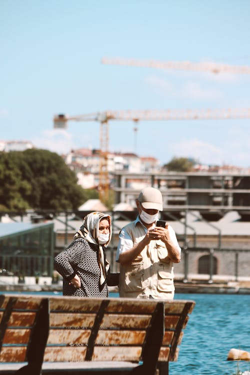 A Woman and Man Looking Smartphone Together 