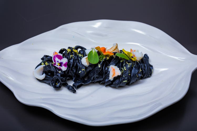 Black Pasta Dish On White Ceramic Plate