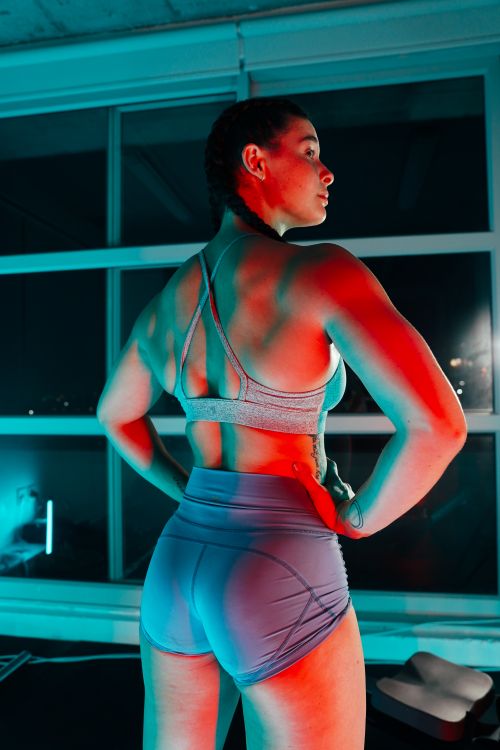 Free A woman stands confidently in a gym, showcasing athleticism and strength. Stock Photo