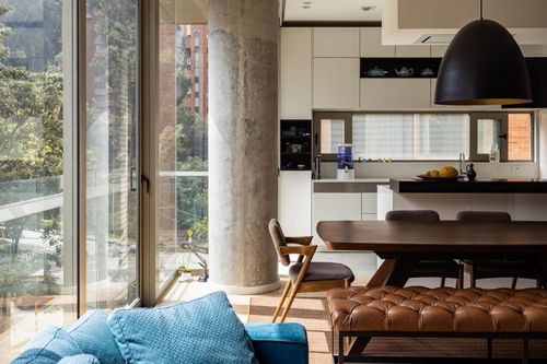 Free Spacious modern apartment in Bogotá featuring a stylish kitchen and living area with abundant natural light. Stock Photo