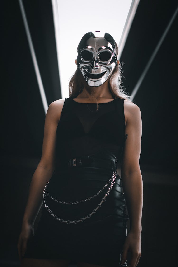 Woman In A Black Outfit And A Mask