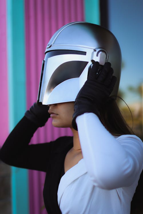 Woman in a Costume Putting on a Helmet