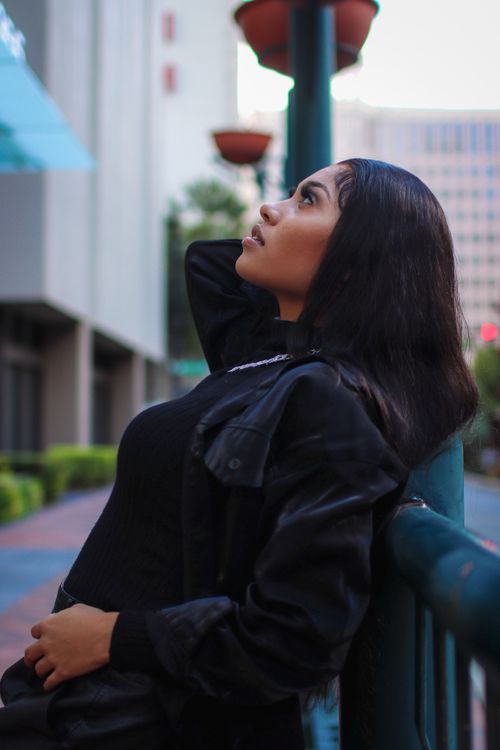 Woman in leather jacket in urban setting