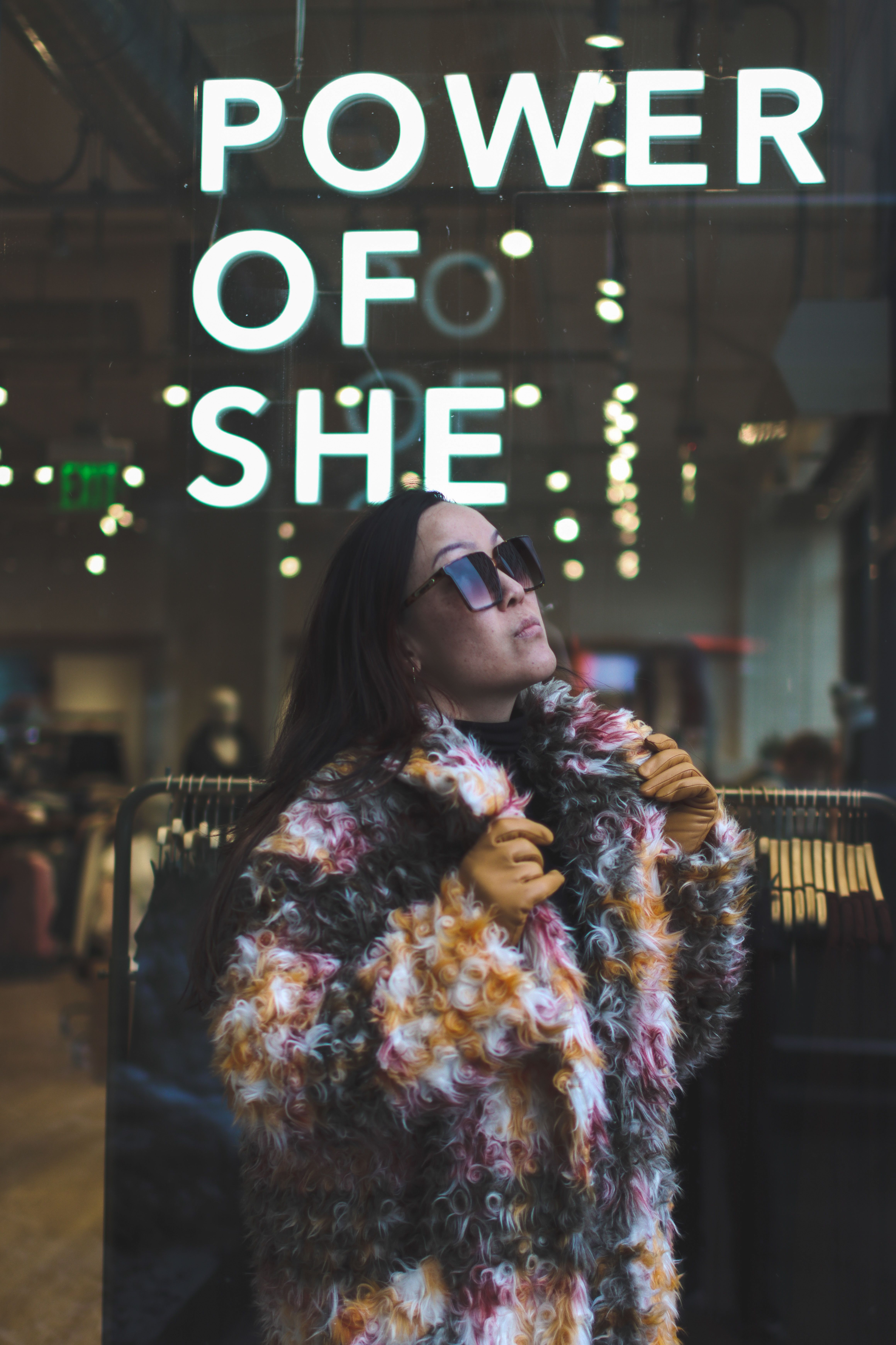 Woman in Fur Coat and Sunglasses Posing on Illuminated Sign Background ...