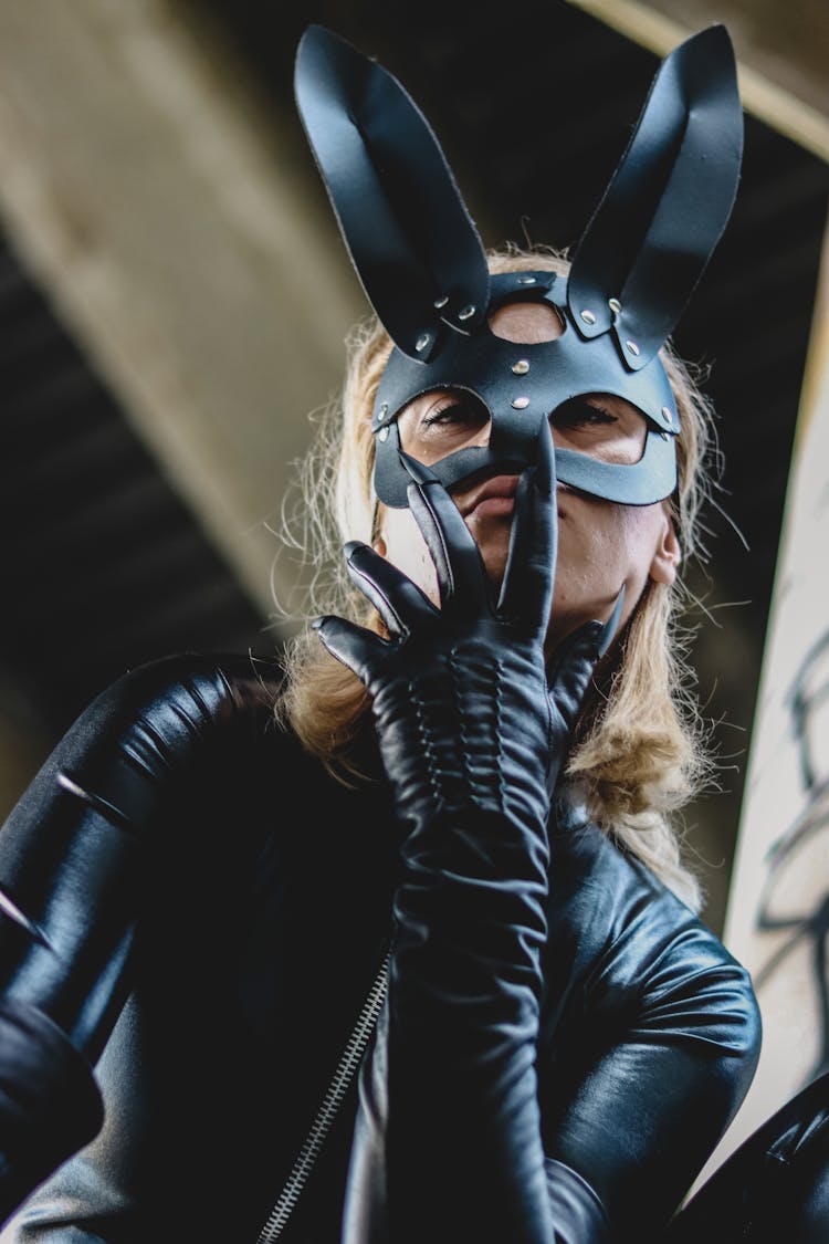 Woman In A Black Costume And A Mask