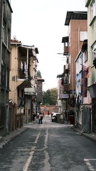 Explore a narrow alleyway in Istanbul featuring colorful buildings and vibrant urban life.