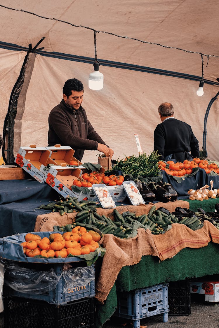 Men Selling Vegetables At The Market 