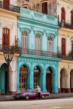 Vibrant vintage architecture and classic car on a street in Havana, Cuba.