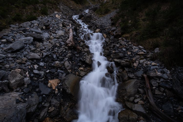 Stream Flowing On Rocks In Mountains