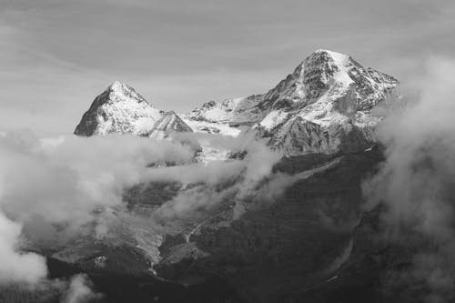 Grayscale Photo of Snow-Covered Mountains