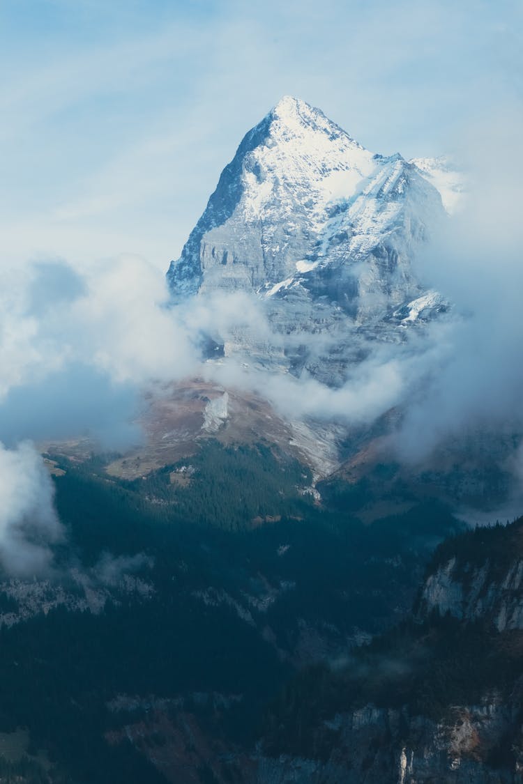 Mountain In Snow In Clouds