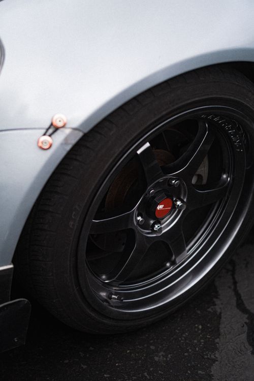 Free Detailed view of a sleek car wheel highlighting its design and tire tread. Stock Photo
