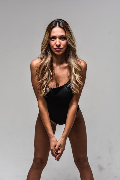 Sexy Woman in Bodysuit Posing in Studio
