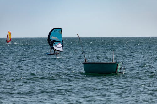 Person Windsurfing on Open Sea