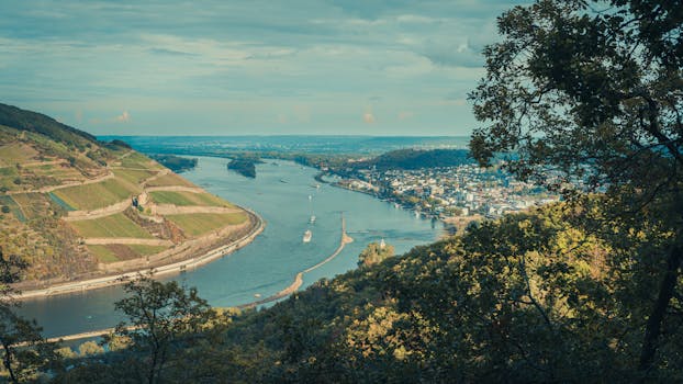 A stunning aerial view of a river winding through lush landscapes and a small town.