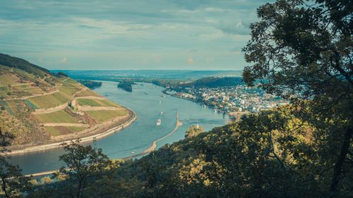 Free A stunning aerial view of a river winding through lush landscapes and a small town. Stock Photo