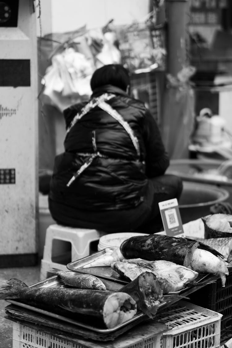 Grayscale Photo Of A Market Vendor