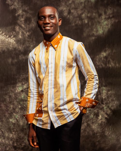 Free Stylish man in a vibrant patterned shirt smiling warmly at the camera. Stock Photo