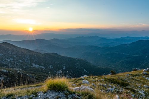 Free Beautiful sunrise over the rugged mountains in Montenegro, showcasing a stunning landscape. Stock Photo