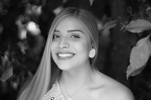 A Grayscale Photo of a Smiling Woman