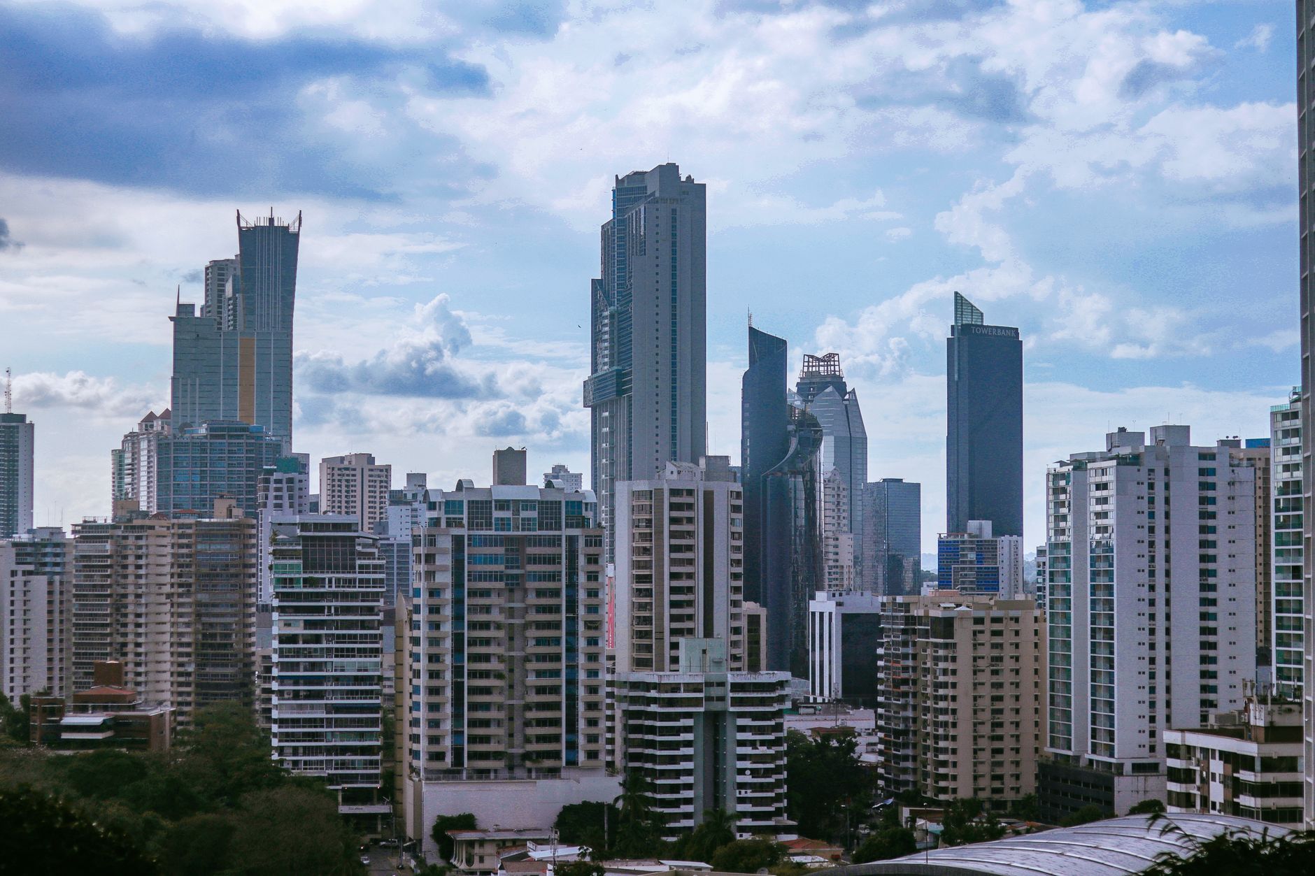 Panama City's modern skyline with towering skyscrapers under a partly cloudy sky. (Photo by Luis Quintero on Pexels)
