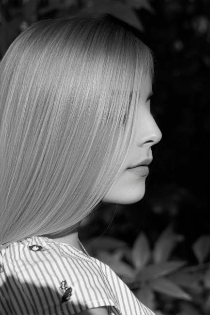Graceful black and white side profile portrait of a woman with sleek hair.