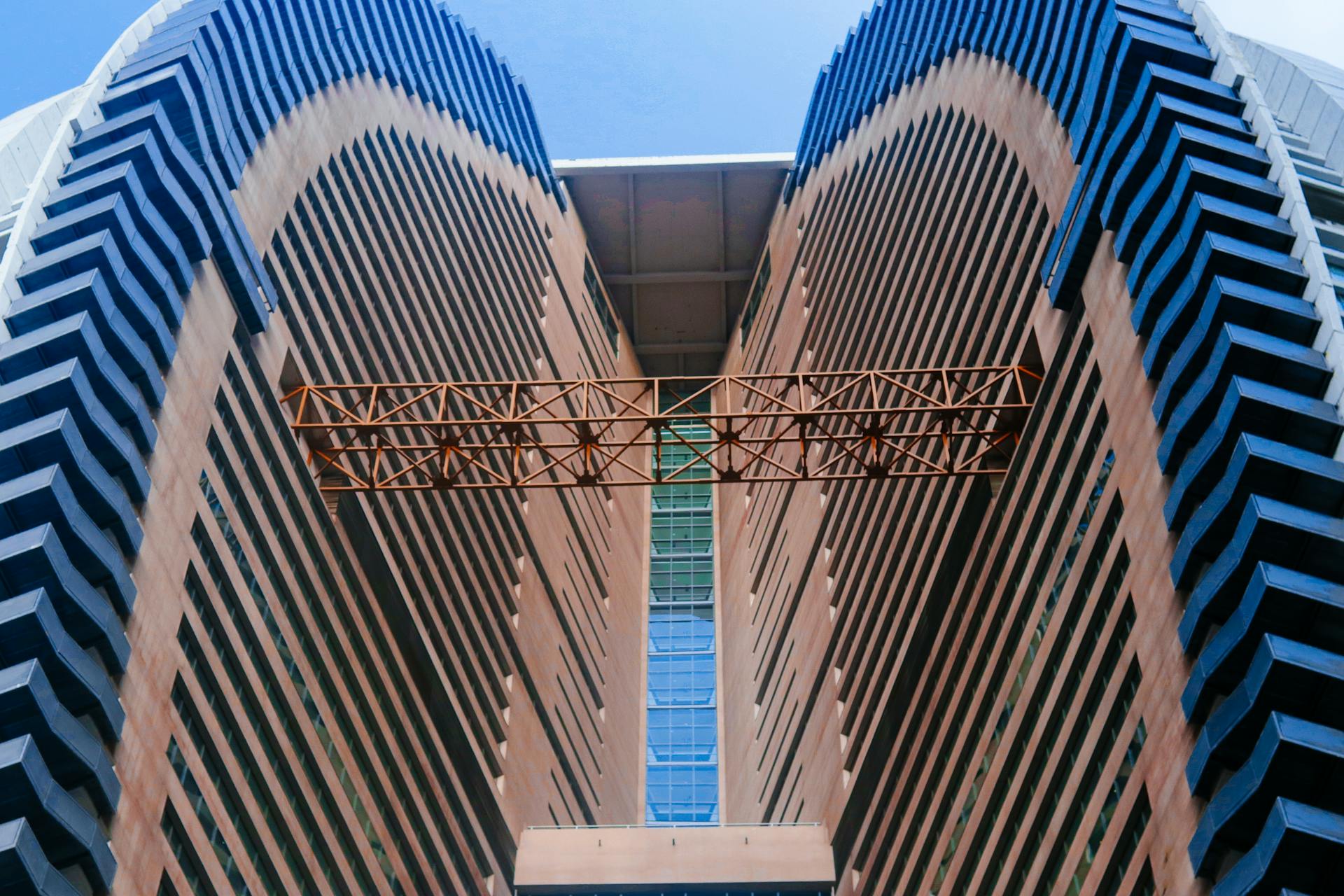 A Blue and Brown Building with a Brown Steel Trusses Between Walls