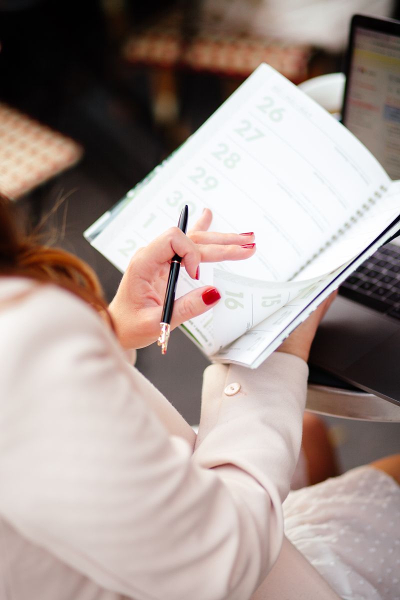 Close-up of a person looking at a wall calendar, planning ahead to stay consistent