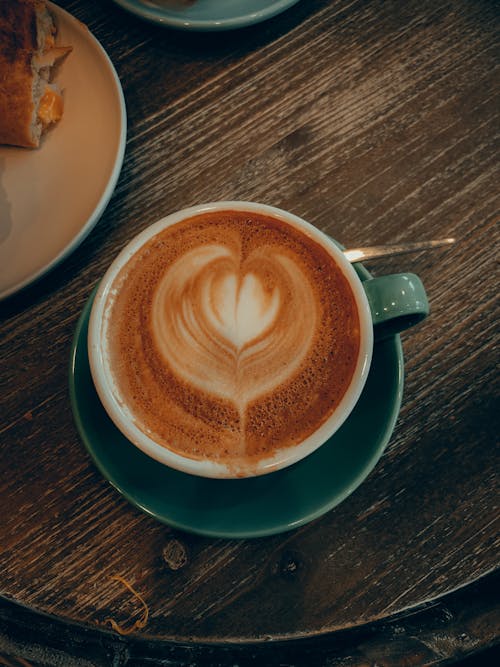 Close-Up Shot of a Latte Art Coffee in Green Ceramic Cup