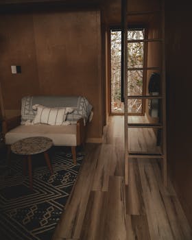 Warm wooden interior design featuring a ladder and sofa, perfect for rustic living spaces.