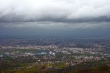 Aerial view of Pune's urban sprawl under stormy clouds