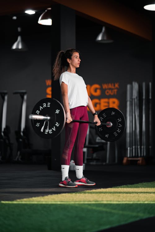 A Woman Lifting a Barbell