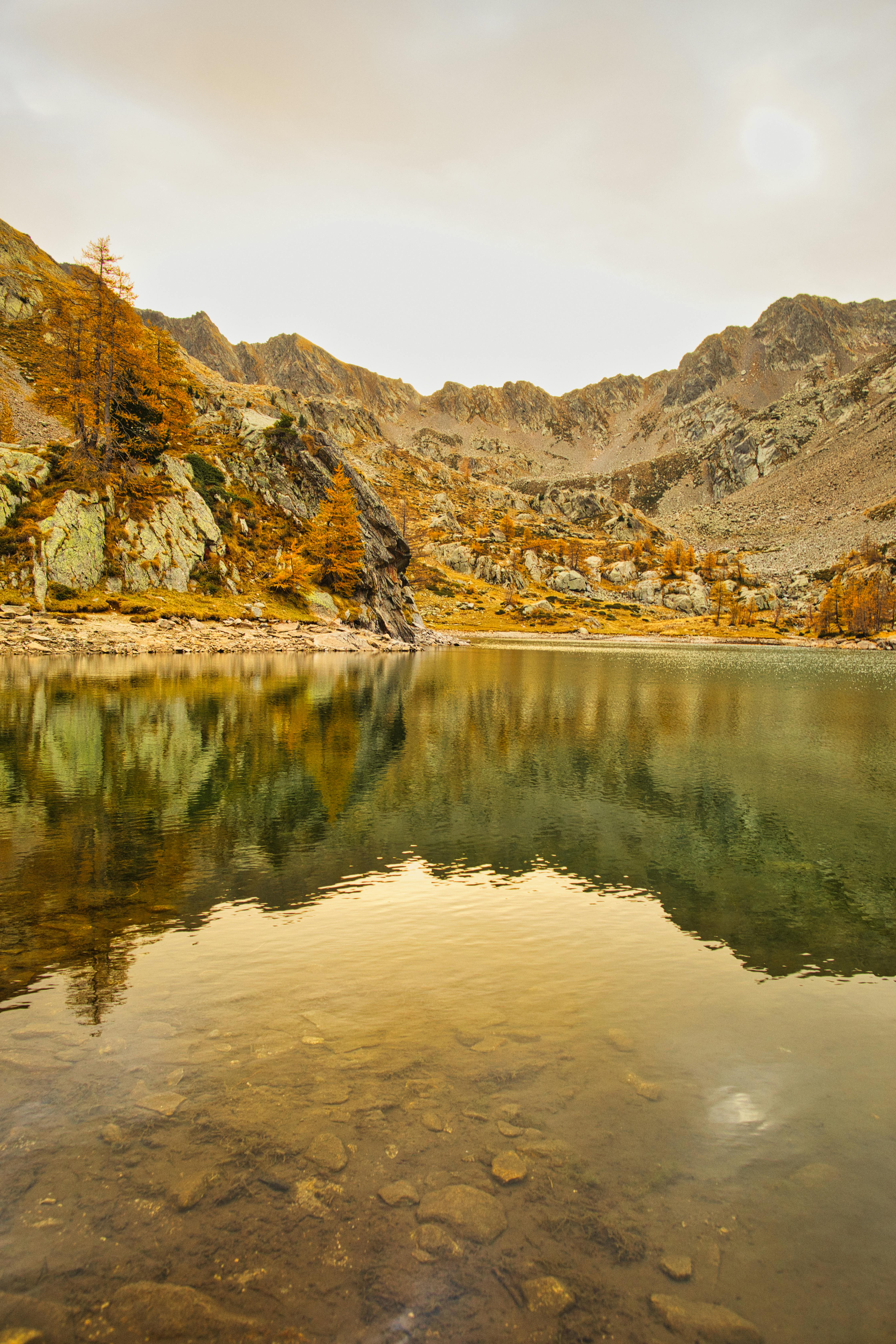 Serene mountain lake with autumn reflections in Nice, France.