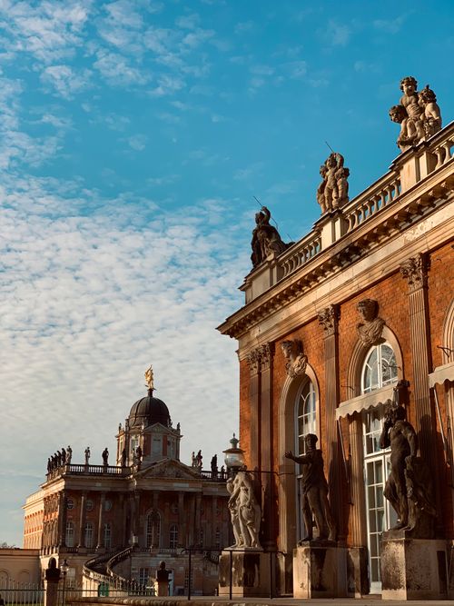 Free Elegant baroque buildings adorned with statues under a vibrant sky. Stock Photo