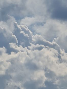 A beautiful view of fluffy, dramatic clouds in a bright sky, creating a serene and atmospheric scene.
