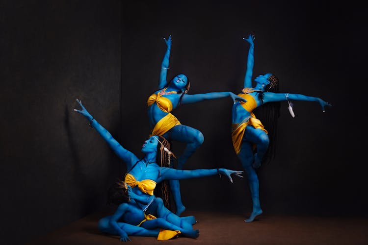 A Group Of Women In Yellow Dress Dancing Gracefully