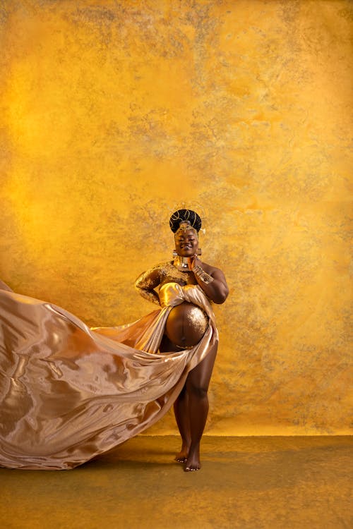 Portait of Barefooted Woman in Pregnancy on Yellow Background