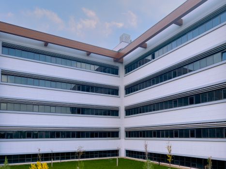 Contemporary office building featuring sleek glass windows and minimalist design.