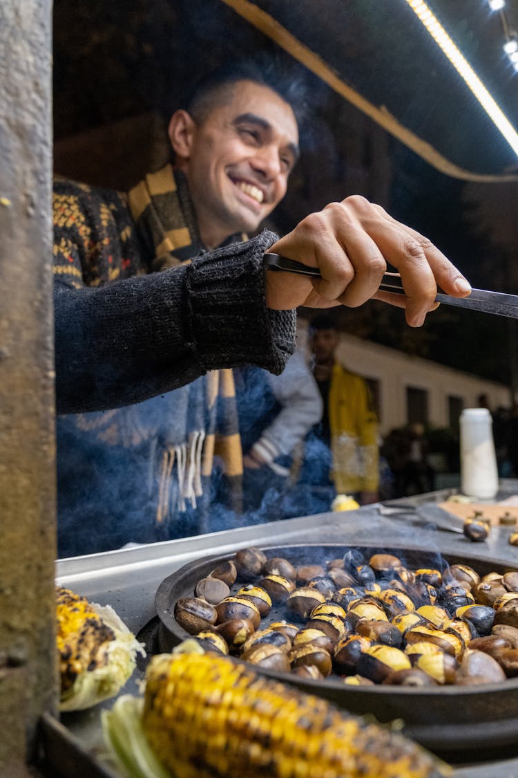 A Man Cooking Foods On The Street