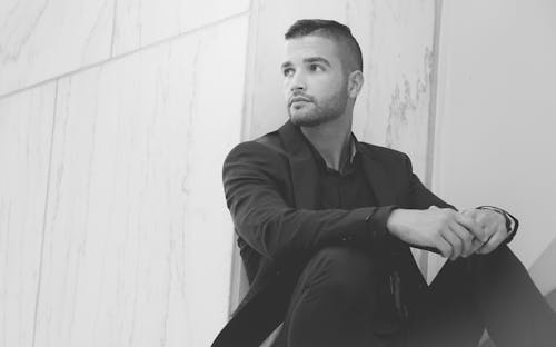 Grayscale Photo of a Man in a Black Suit 