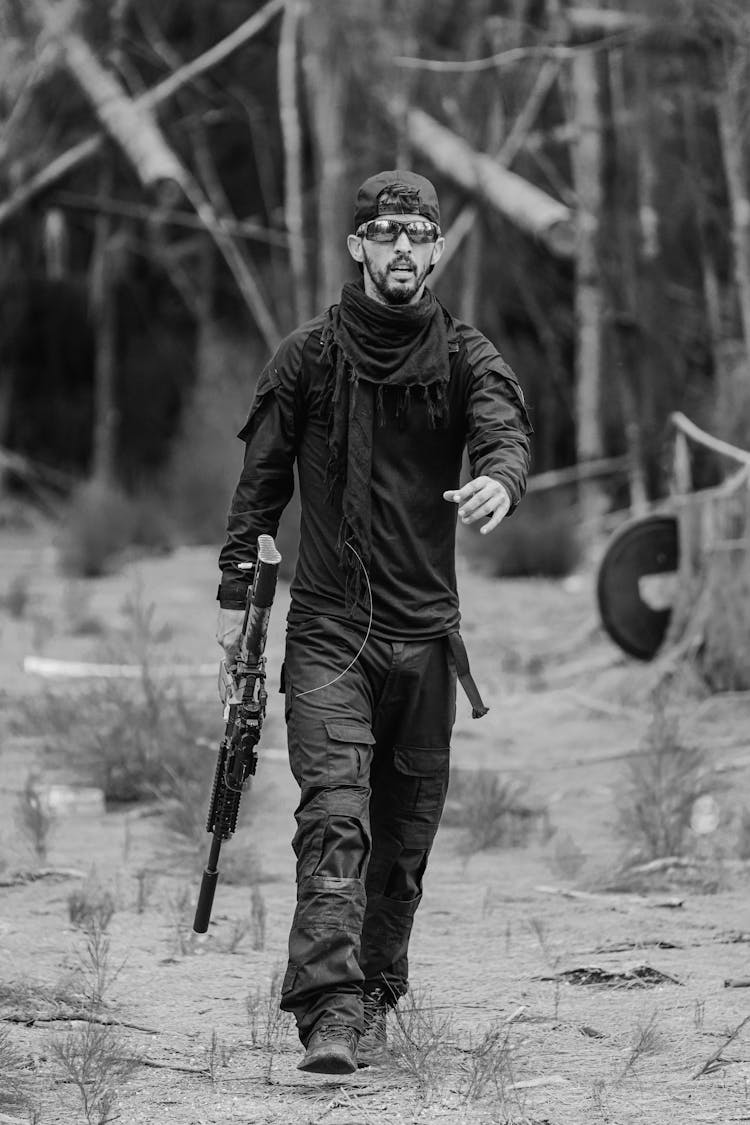 Grayscale Photo Of Man Holding A Rifle