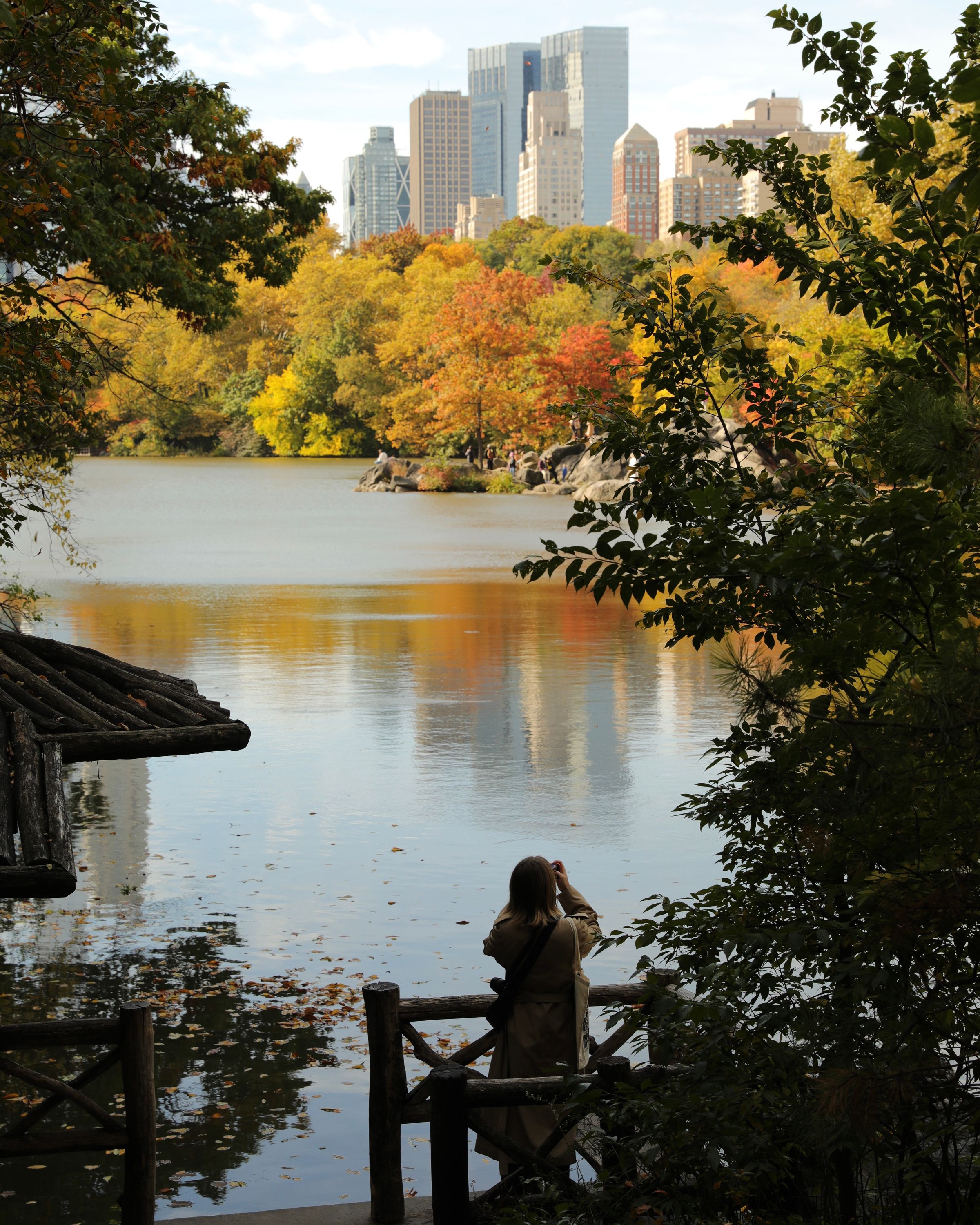People walking through autumn foliage in Central Park New York