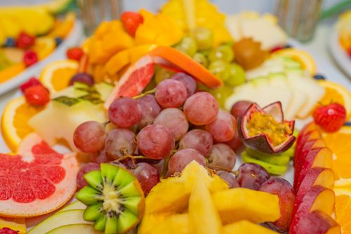 Free A variety of fresh fruits including grapes, kiwis, and passionfruit in a vibrant, healthy display. Stock Photo