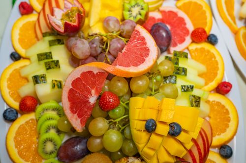 Free Vibrant and delicious fruit platter featuring grapefruit, mango, kiwi, and more. Stock Photo