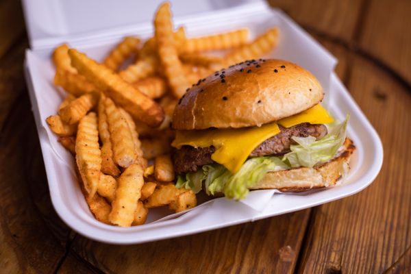 Cheeseburger with crinkle-cut fries in a basket — photo by Alan Retano on Pexels