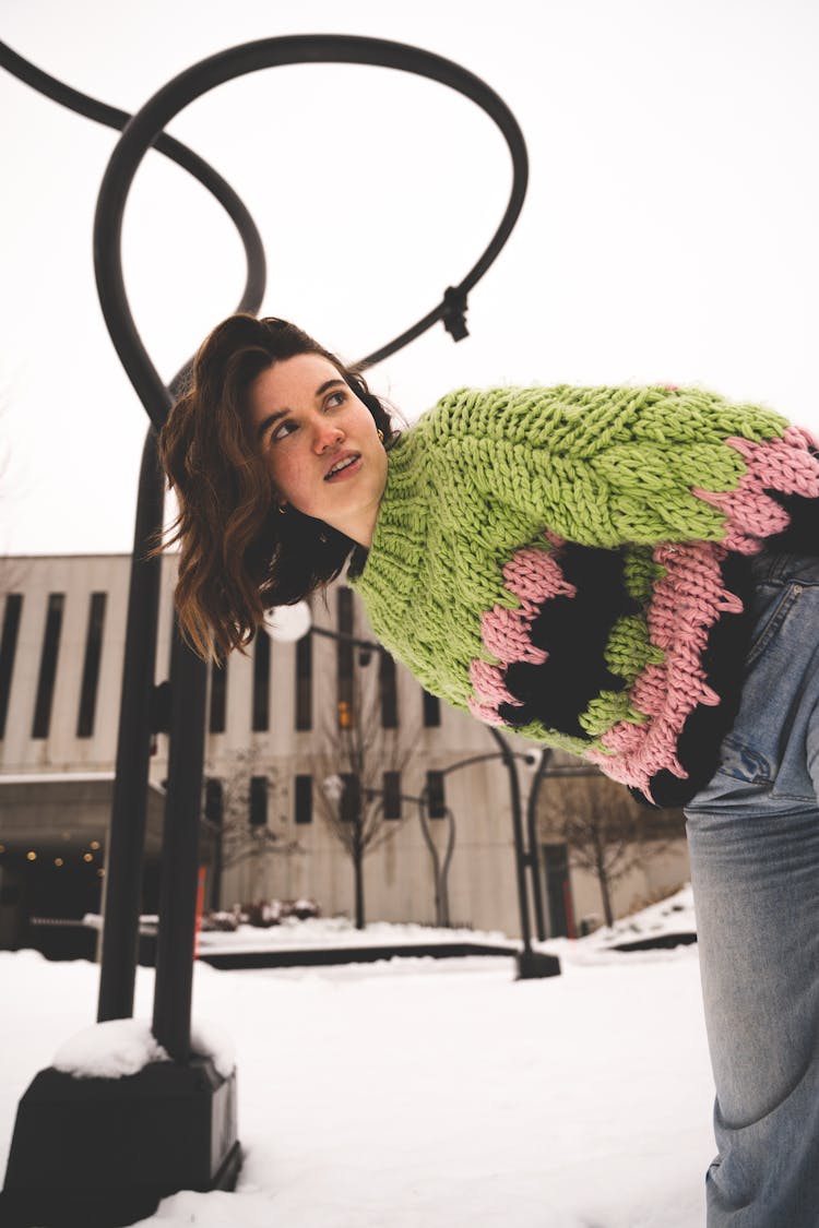 Young Woman Wearing Jeans And Sweater Standing Outside In Winter 